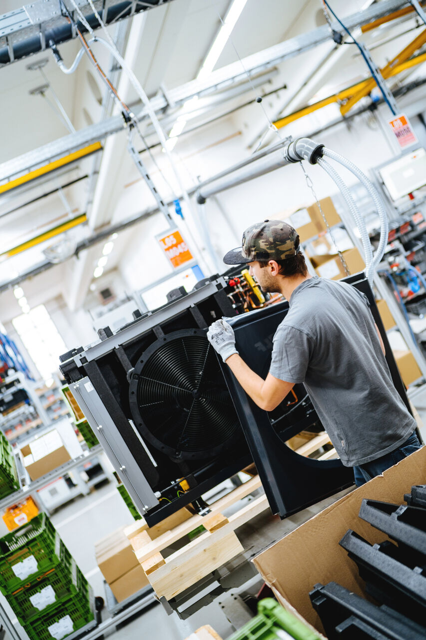 Worker in a heat pump factory
